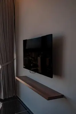a flat screen tv hanging on a wall at Urban Suites with Spectacular High Floor View #3BR #03 in Jelutong
