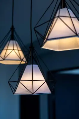 three lights are hanging from the ceiling in a room at Urban Suites with Spectacular High Floor View #3BR #03 in Jelutong