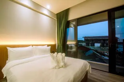 a hotel room with a bed with a large window at Crosview in Kampung Sepetang