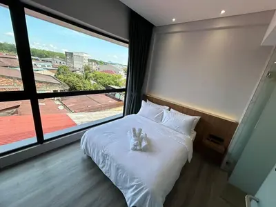 a bedroom with a bed with two stuffed animals on it at Crosview in Kampung Sepetang