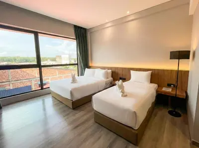 a hotel room with two beds and a large window at Crosview in Kampung Sepetang