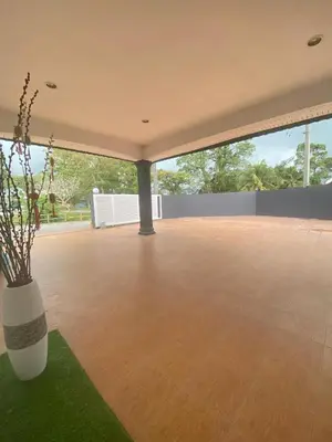 a large empty patio with a vase on the grass at IPOH LYL EVERGREEN HOMESTAY 12pax in Ipoh