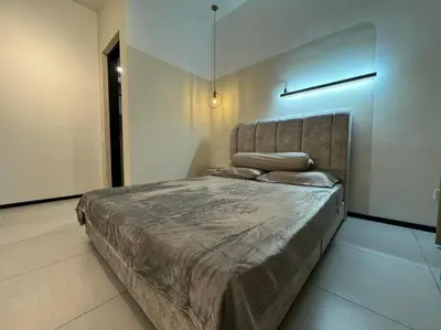 a bedroom with a large bed in a room at Urban Suites Stylish 3BR in Georgetown with Stunning Seaview in Jelutong