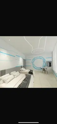 a bedroom with two beds and a blue wall at One Stop Hotel Ipoh in Ipoh