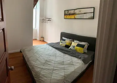 a bedroom with a bed with two pillows on it at HappyHomestay in Brinchang