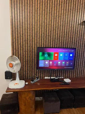 a desk with a television and a fan on it at HappyHomestay in Brinchang