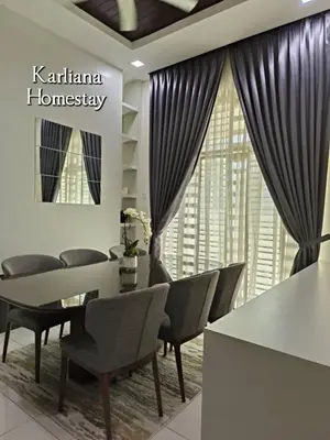 a dining room with a table and chairs and a window at Modern Classy Karliana Homestay Penang in Kepala Batas