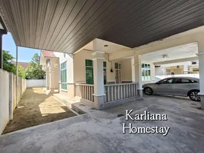 a house with a car parked in a driveway at Modern Classy Karliana Homestay Penang in Kepala Batas