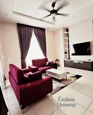 a living room with a couch and a tv at Modern Classy Karliana Homestay Penang in Kepala Batas