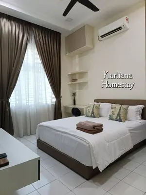 a bedroom with a large bed in front of a window at Modern Classy Karliana Homestay Penang in Kepala Batas