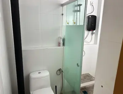 a bathroom with a toilet and a glass shower at Nibong Tebal Studio Home Stay in Nibung Tebal