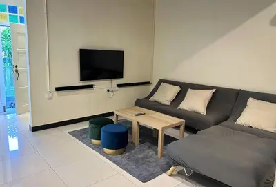 a living room with a couch and a tv at Nibong Tebal Studio Home Stay in Nibung Tebal