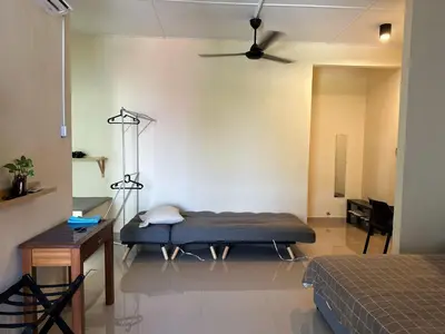 a room with a bed and a ceiling fan at Nibong Tebal Studio Home Stay in Nibung Tebal