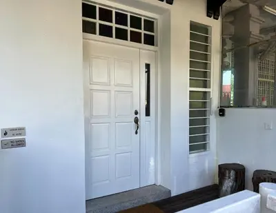 a white door in a room with a window at Nibong Tebal Studio Home Stay in Nibung Tebal