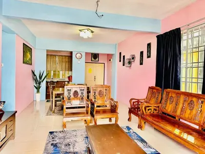 a living room with two chairs and a table at Zurie Muslim Homestay in Brinchang