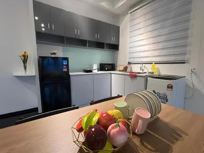 a kitchen with a bowl of fruit on a table at Urban Suites R l 6pax 2R2B l SeaView &CityView l Georgetown in Jelutong