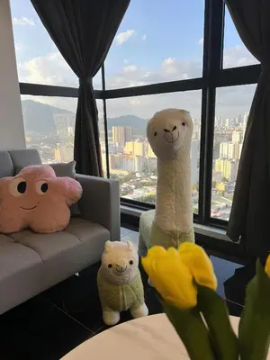 three stuffed animals sitting in front of a window at Urban Suites R l 6pax 2R2B l SeaView &CityView l Georgetown in Jelutong