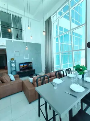 a living room with a table and a couch at Maritime Suite @ George town by Cohans in Jelutong