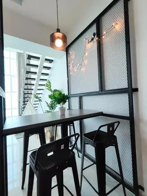 a dining room with a black table and chairs at Maritime Suite @ George town by Cohans in Jelutong
