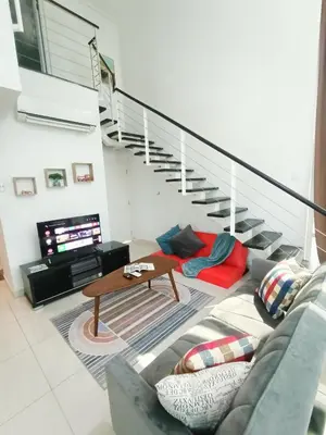 a living room with a couch and a table at Maritime Suite @ George town by Cohans in Jelutong