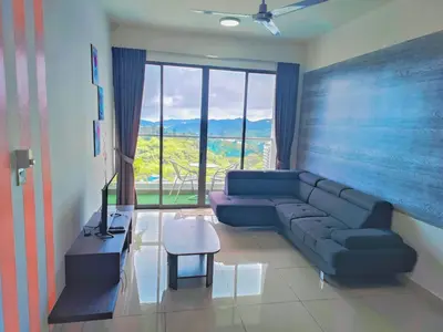 a living room with a blue couch and a large window at Cooling Point Homestay @ Palas Horizon Residence in Cameron Highlands