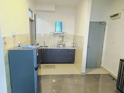 a kitchen with a blue refrigerator and a sink at Cooling Point Homestay @ Palas Horizon Residence in Cameron Highlands