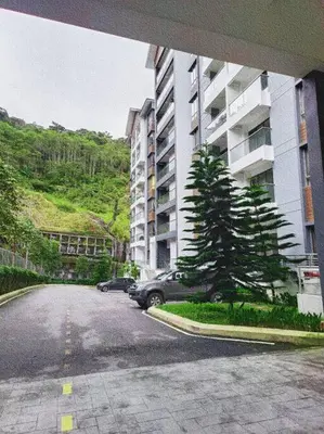 a car parked in a parking lot next to a building at Cooling Point Homestay @ Palas Horizon Residence in Cameron Highlands