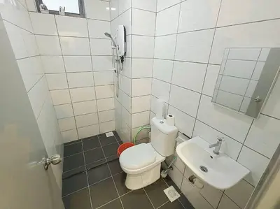 a small bathroom with a toilet and a sink at Cooling Point Homestay @ Palas Horizon Residence in Cameron Highlands