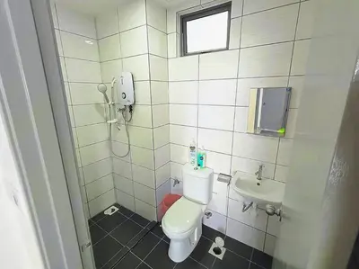 a small bathroom with a toilet and a sink at Cooling Point Homestay @ Palas Horizon Residence in Cameron Highlands