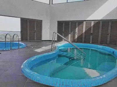 a large swimming pool with blue water in a building at Cooling Point Homestay @ Palas Horizon Residence in Cameron Highlands