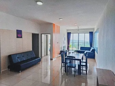 a living room with a couch and a table and chairs at Cooling Point Homestay @ Palas Horizon Residence in Cameron Highlands