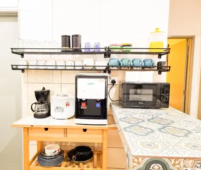 a kitchen with a counter with a laptop on a counter sidx sidx sidx at Mossy Forest Family Retreat II, 2-8 pax, Cameron Highlands in Cameron Highlands