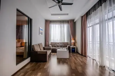 a living room with a couch and a large window at Nova Highlands Hotel in Cameron Highlands