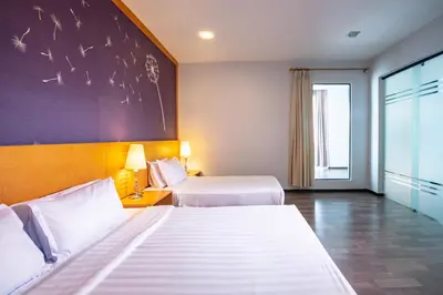 a hotel room with two beds and a large window at Nova Highlands Hotel in Cameron Highlands