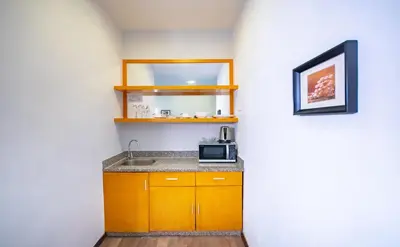 a small kitchen with a sink and a microwave at Nova Highlands Hotel in Cameron Highlands