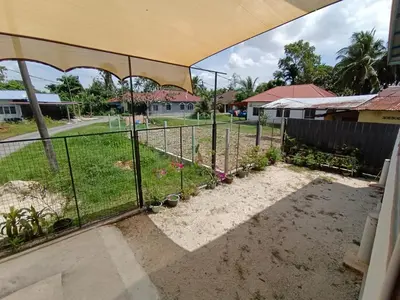 a fence in front of a yard at Rods Homestay - Kg Agong Penaga in Kepala Batas