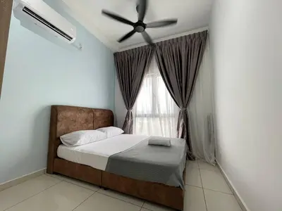 a bedroom with a bed with a ceiling fan and a window at Seri Ipoh - Horizon Apartment in Ipoh