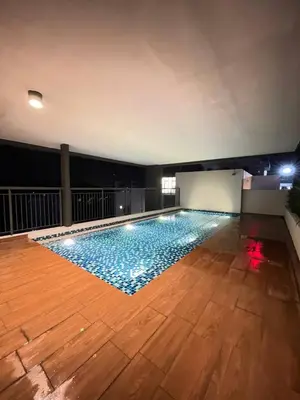 a large swimming pool in a room with a wooden floor at Seri Ipoh - Horizon Apartment in Ipoh