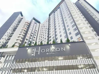 a large building with a hilton sign in front of it at Seri Ipoh - Horizon Apartment in Ipoh