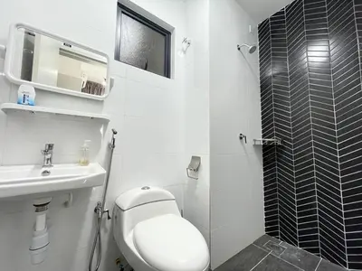 a white bathroom with a toilet and a sink at Seri Ipoh - Horizon Apartment in Ipoh
