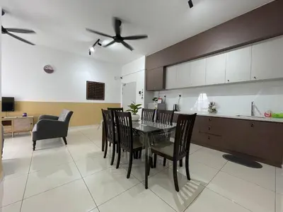 a kitchen and dining room with a table and chairs at Seri Ipoh - Horizon Apartment in Ipoh