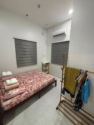 a bedroom with a bed in a room at Aufa House in Padang Rengas