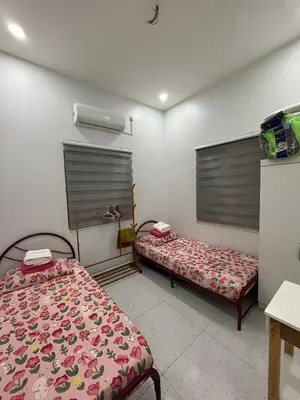 a room with two beds in a room at Aufa House in Padang Rengas