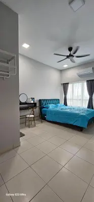 a bedroom with two beds and a ceiling fan at IPOH Town R&E Homestay in Ipoh