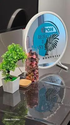 a mirror and a vase on a table with a plant at IPOH Town R&E Homestay in Ipoh