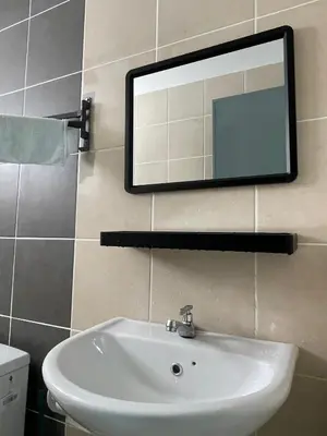 a bathroom with a sink and a mirror on the wall at IPOH Town R&E Homestay in Ipoh