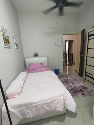 a bedroom with a large bed with a ceiling fan at Homestay Gerik Le rizq Homestay~ Heart of Gerik ~ Cozy in Gerik