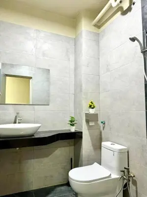 a bathroom with a white toilet and a sink at YK Sweet home sungai petani 1 @ 16 people above in Sungai Petani