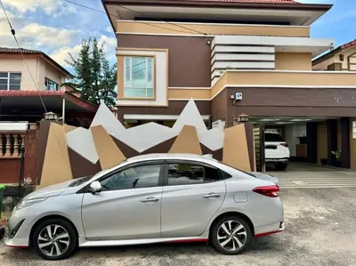 a white car parked in front of a building at YK Sweet home sungai petani 1 @ 16 people above in Sungai Petani