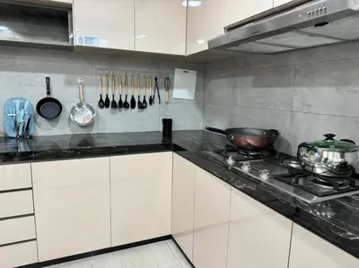 a kitchen with white cabinets and a stove and utensils at YK Sweet home sungai petani 1 @ 16 people above in Sungai Petani